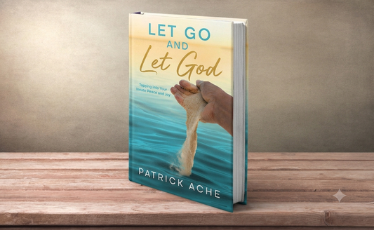A book titled "Let Go and Let God" by Patrick Ache, standing upright on a wooden surface against a textured beige background. The cover shows a hand holding and throwing sand over blue water, symbolizing letting go, with the title in teal and gold lettering.